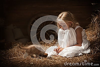 Girl feeding a kitten milk Stock Photo