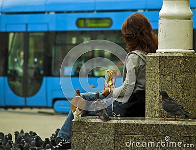 Girl Feeding A Pidgeons Editorial Stock Photo