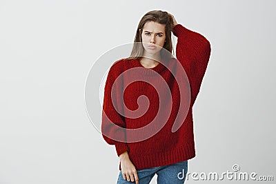 Girl feeling bothered not knowing answer to question. Portrait of displeased gloomy european woman in trendy loose Stock Photo