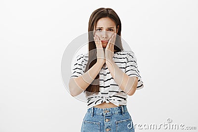 Girl feeling sad of terrible toothache, needing remove wisdom tooth. Portrait of upset worried cute female, squeezing Stock Photo