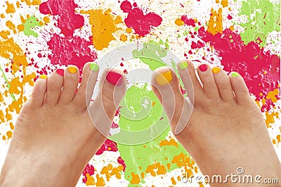 Girl feet with rainbow colorful nails Stock Photo