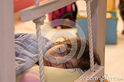 The girl fell asleep in the light turned on Stock Photo