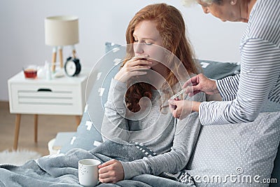 Girl with fever in bed Stock Photo