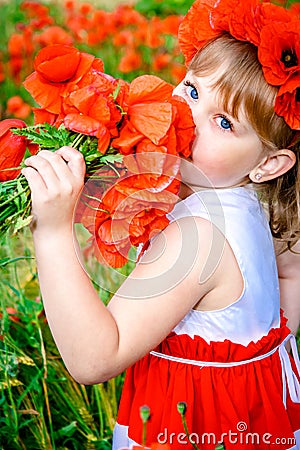 Girl in the field with a bouquet of poppies Stock Photo