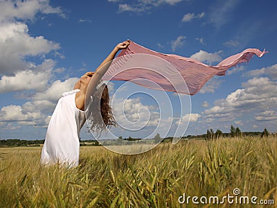 Girl in a field with a pink scarf Stock Photo