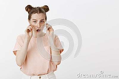 Girl find out terrible rumor, being shocked and impressed, dropping jaw from amazement, taking off glasses and staring Stock Photo