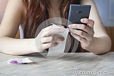 The girl finds checks receipts, purchases on the phone, calculation Stock Photo