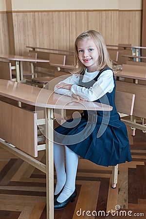 Girl in the first grade, is sitting at the desk Stock Photo