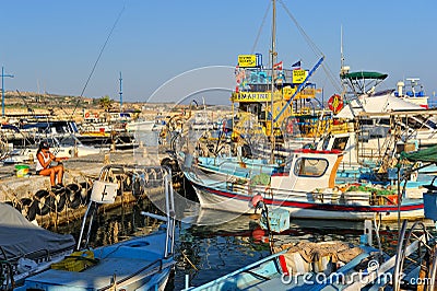 Girl fishing among fishing boats Editorial Stock Photo