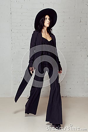 Girl in flares, tuxedos hat to make a step Stock Photo