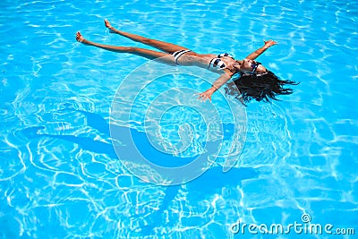 Girl floating in the pool Stock Photo