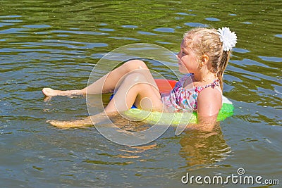 Girl floating in the river Stock Photo