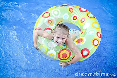 Girl floating in swimming pool Stock Photo