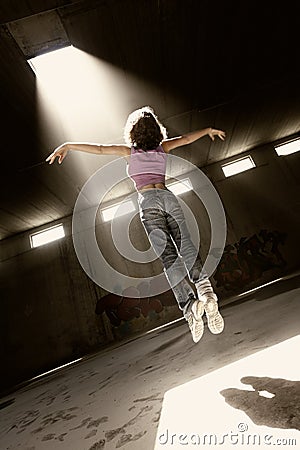 Girl floating up to bright light. Stock Photo