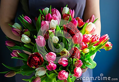 Girl florist holding a bouquet of tulips Stock Photo