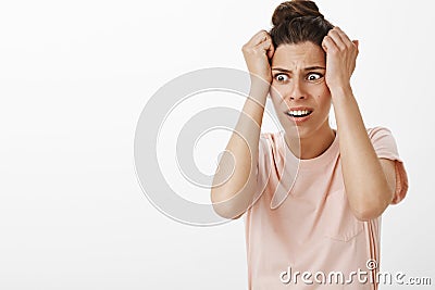 Girl freaking out starting panic as realising she pregnant feeling worried and anxious holding hands on head frowning Stock Photo