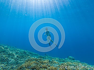 Girl freediving in clear sea Southeast Asia Stock Photo