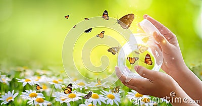 The girl frees the butterfly from the jar, golden blue moment Concept of freedom Stock Photo