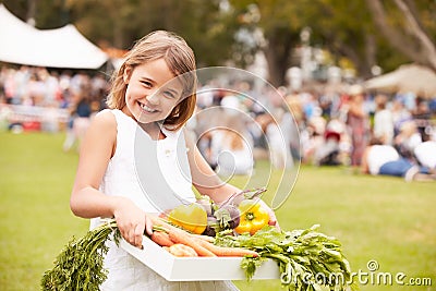 Girl With Fresh Produce Bought At Outdoor Farmers Market Stock Photo