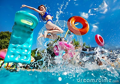 Girl and friends dive in swim pool splash to water Stock Photo