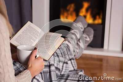 Winter Coziness: Fireside Reading Retreat Stock Photo