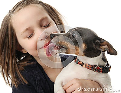 Girl getting kisses from dog Stock Photo