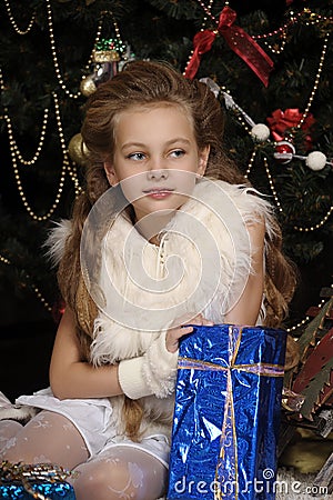 Girl with a gift in blue packaging Stock Photo