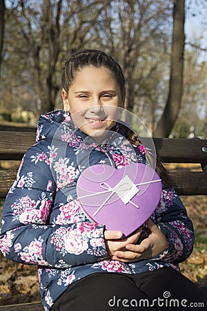 The girl with a gift in the park Stock Photo