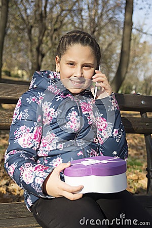 The girl with a gift in the park Stock Photo