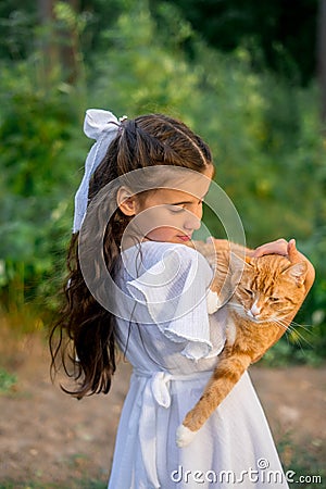 Girl with ginger cat. Beautiful portrait of girl with ginger cat in the hands. Stock Photo