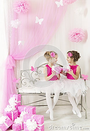 Girl giving children birthday present to sister. Kids gift boxes Stock Photo