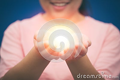 Girl Giving Miracle or Hope in her Hands Stock Photo