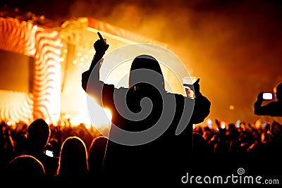 Girl with glass of beer enjoying the music festival, concert Stock Photo