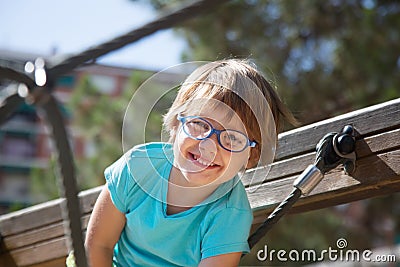 Girl in glass climbing the ropes of challenge net Stock Photo