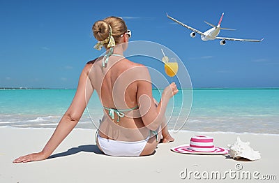 Girl with a glass of orange juice on the beach Stock Photo