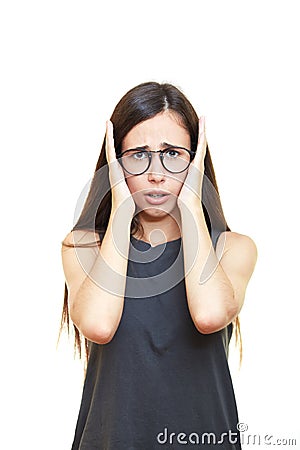 Stressed young business woman covering her ears isolated on whit Stock Photo