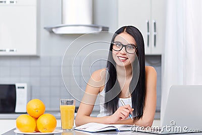 Girl in glasses studding on kitchen. Stock Photo