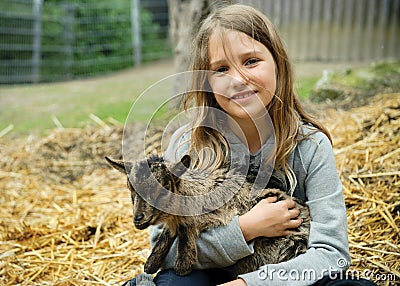 Girl with goatling Stock Photo