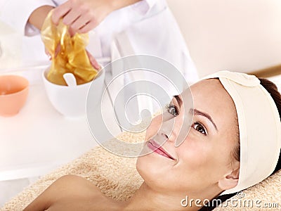 Girl with gold facial mask. Stock Photo