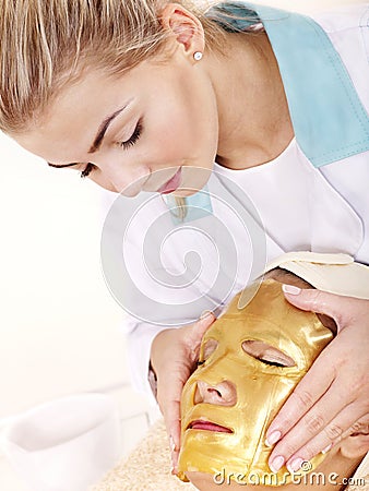 Girl with gold facial mask. Stock Photo