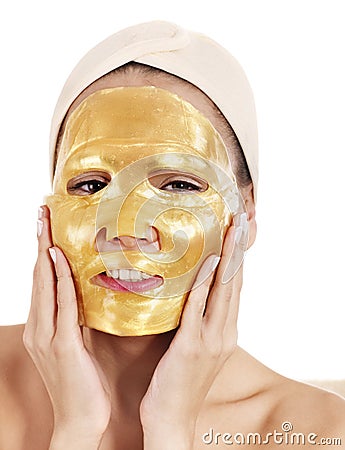 Girl with gold facial mask. Stock Photo