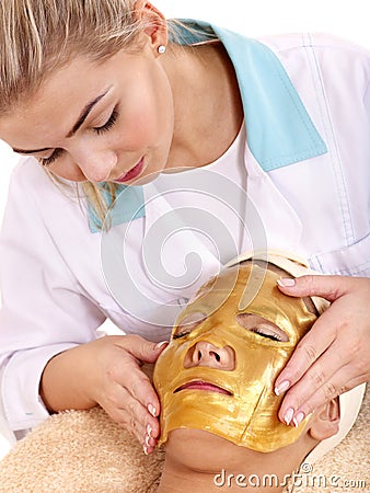 Girl with gold facial mask. Stock Photo