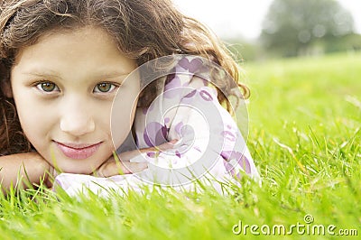 Girl on grass in park. Stock Photo