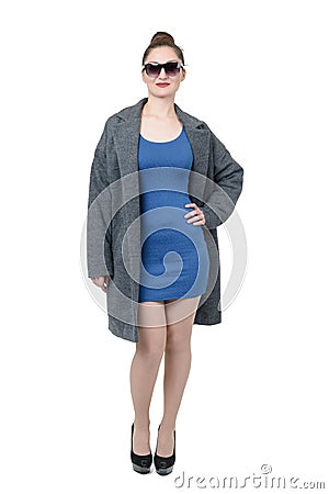 Girl in gray coat and blue dress in heels on white background Stock Photo
