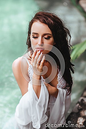 Girl in green swimsuit chilling out near private pool Stock Photo