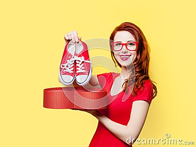 Girl with gumshoes and gift box Stock Photo
