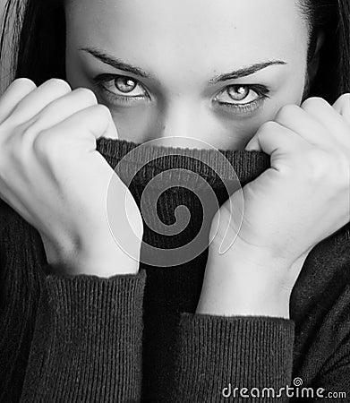 Girl with half face tighting pullover Stock Photo