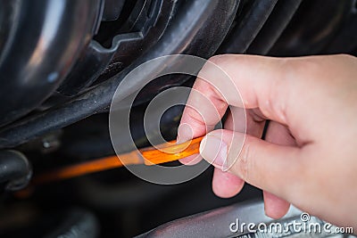 Girl hand check engine oil level Stock Photo