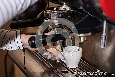 Artisanal Perfection: Girl Hand Crafting Espresso on Retro Coffee Machine in Pub Stock Photo