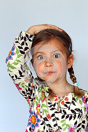 Girl with hand on head Stock Photo